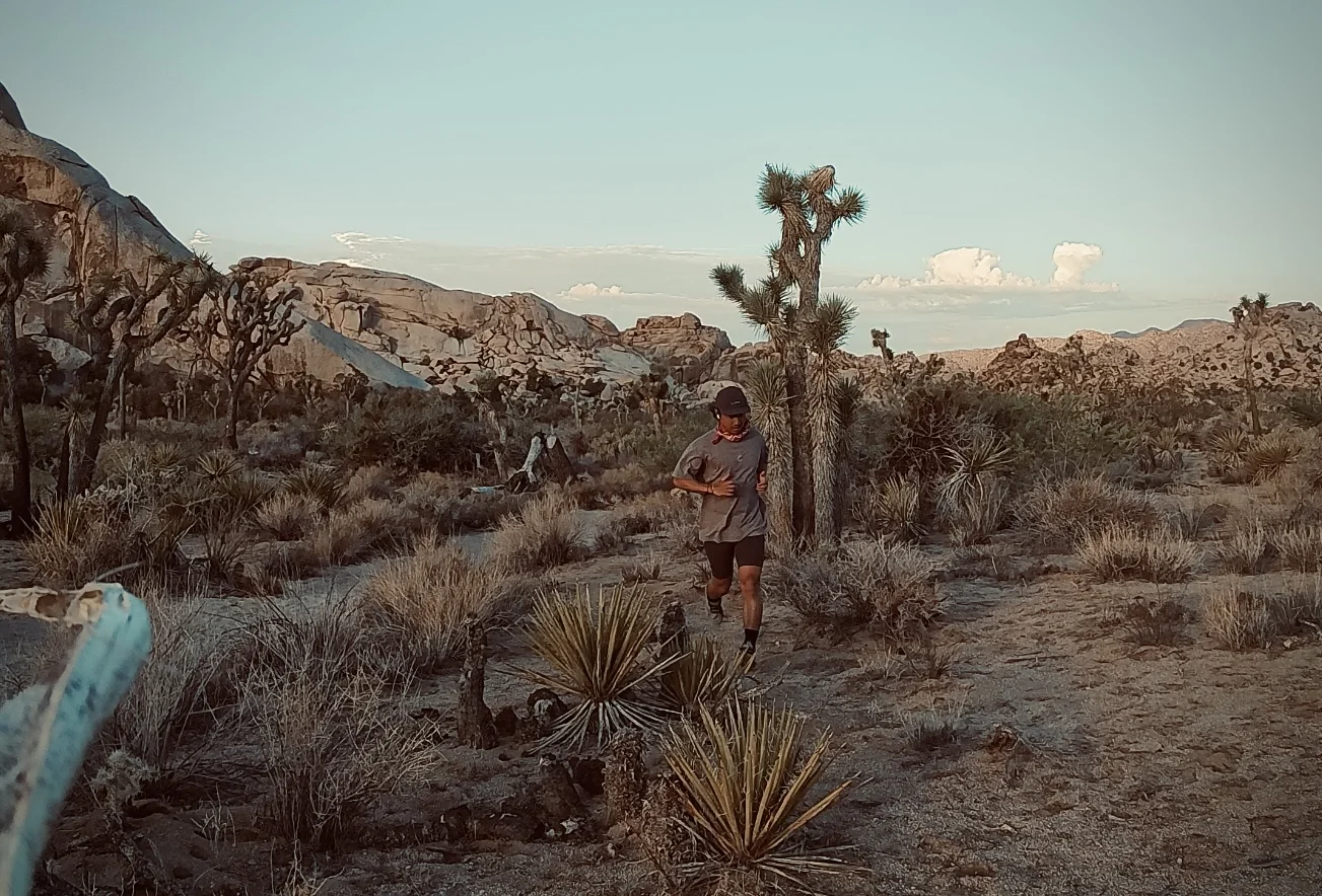 Taishi Okano running through Joshua Tree desert landscape